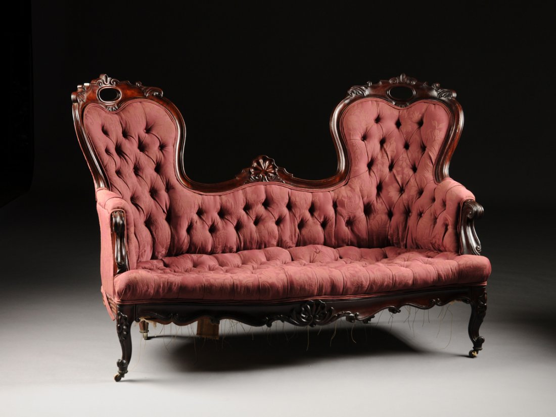 AN AMERICAN ROCOCO REVIVAL ROSEWOOD DOUBLE BACK DAMASK: AN AMERICAN ROCOCO REVIVAL ROSEWOOD DOUBLE BACK DAMASK UPHOLSTERED AND TUFTED SETTEE, CIRCA 1840, the central hump back cavetto molded crest rail surmounted by a stylized shell pendant, continuing to 