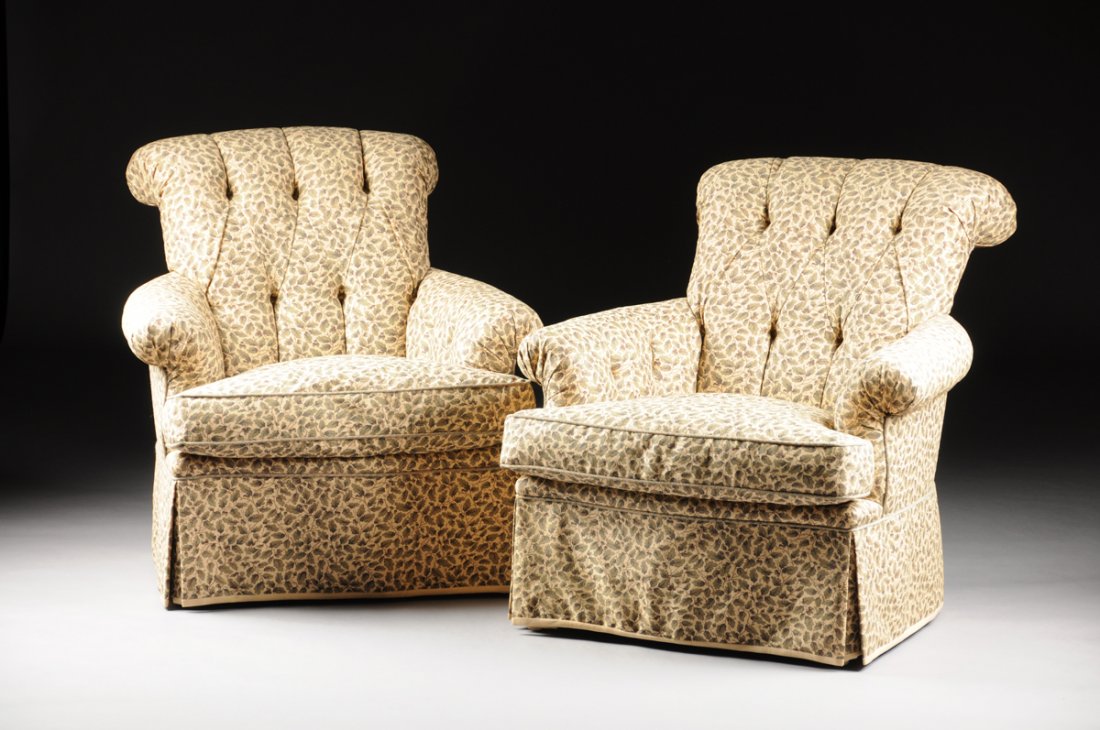 A PAIR OF PLUSH UPHOLSTERED ARM CHAIRS, 20TH CENTURY,: A PAIR OF PLUSH UPHOLSTERED ARM CHAIRS, 20TH CENTURY, the scrolled back back rest with tufted upholstery leading to outswept arms ending in scrolling terminals, the seat cushion with down filling, ove