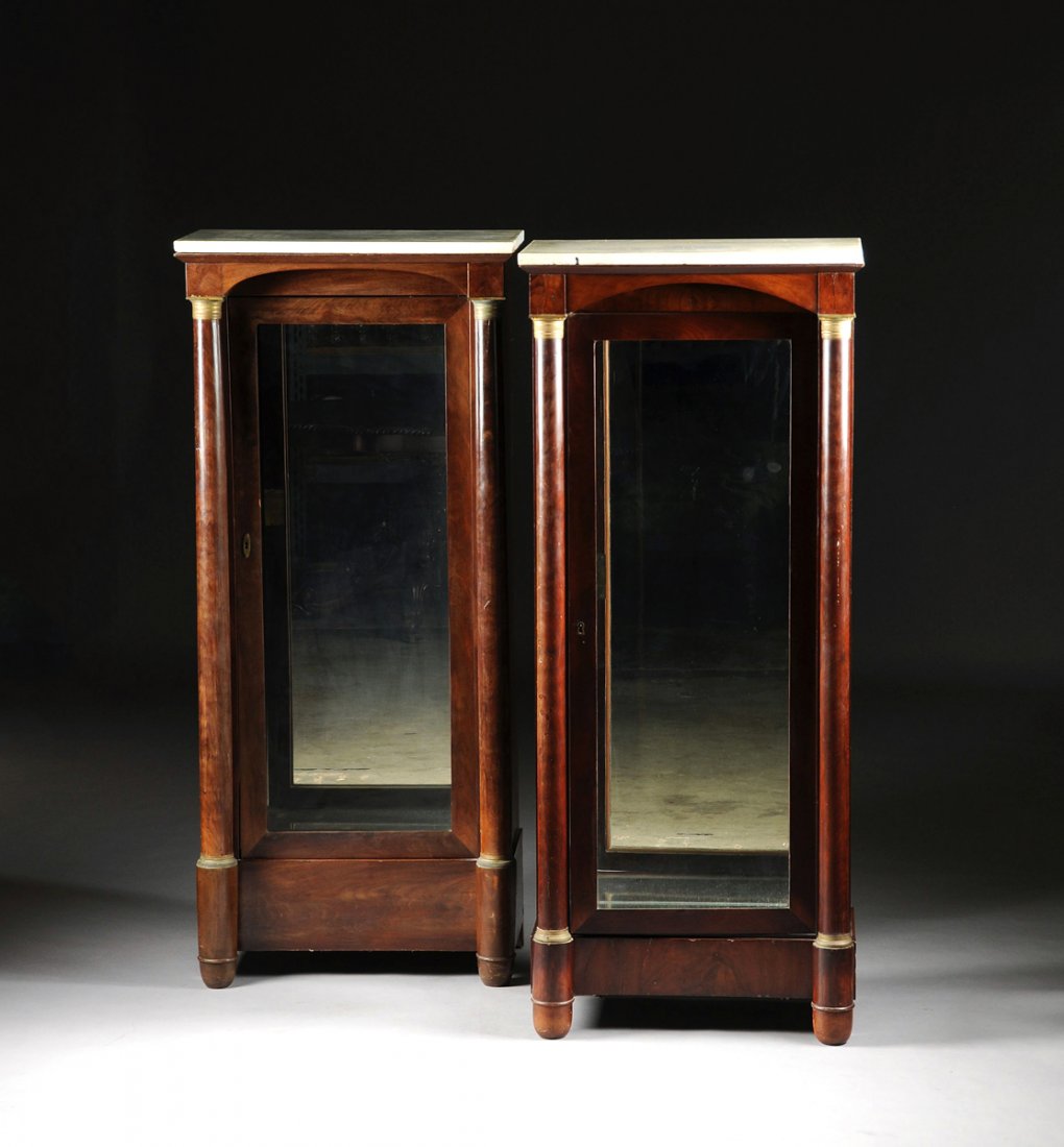 A MATCHED PAIR OF RESTAURATION STYLE GILT BRONZE: A MATCHED PAIR OF RESTAURATION STYLE GILT BRONZE MOUNTED MAHOGANY VITRINES, SECOND QUARTER 19TH CENTURY, each with a rectangular gray veined white marble top above an arched cornice and glazed door op