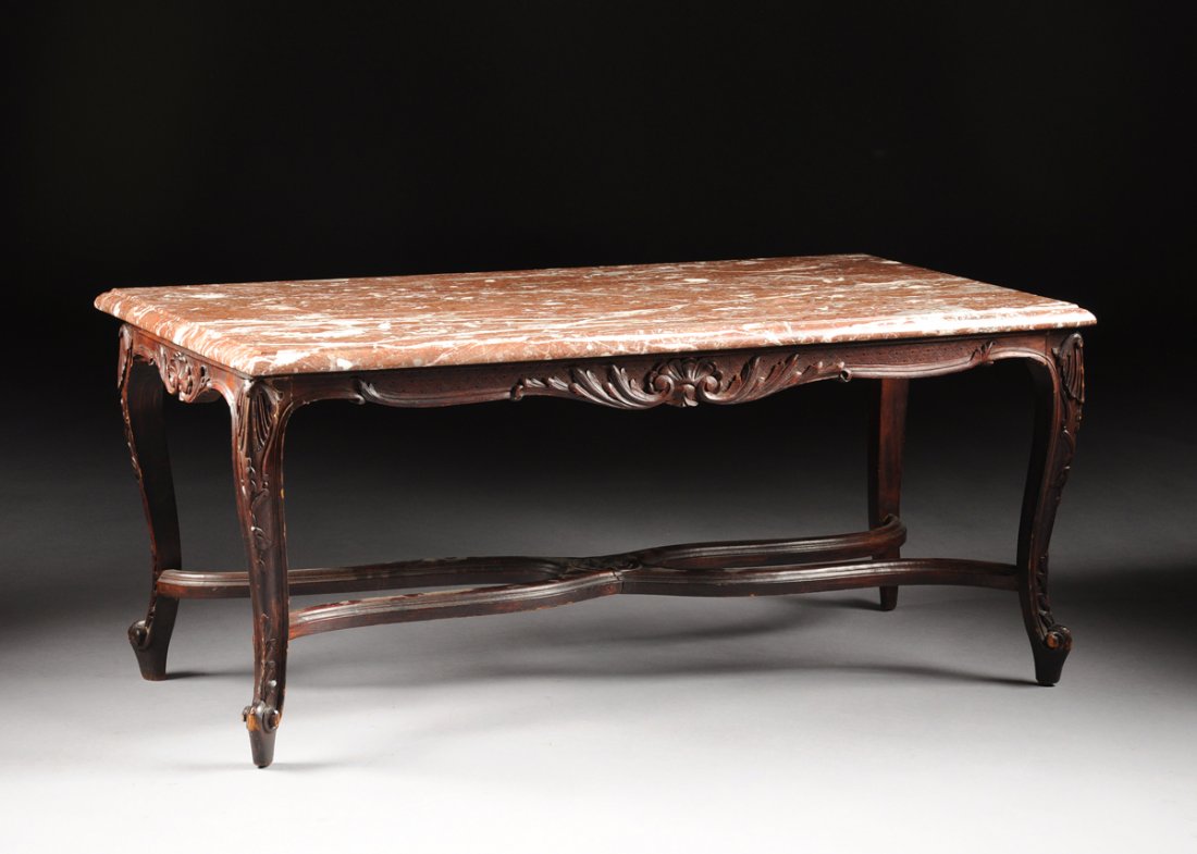 A LOUIS XV STYLE CARVED WALNUT AND MARBLE OCCASIONAL: A LOUIS XV STYLE CARVED WALNUT AND MARBLE OCCASIONAL LOW TABLE, the rectangular variegated brown marble top with molded edge above a serpentine frieze carved with scrolling acanthus on cabriole legs w