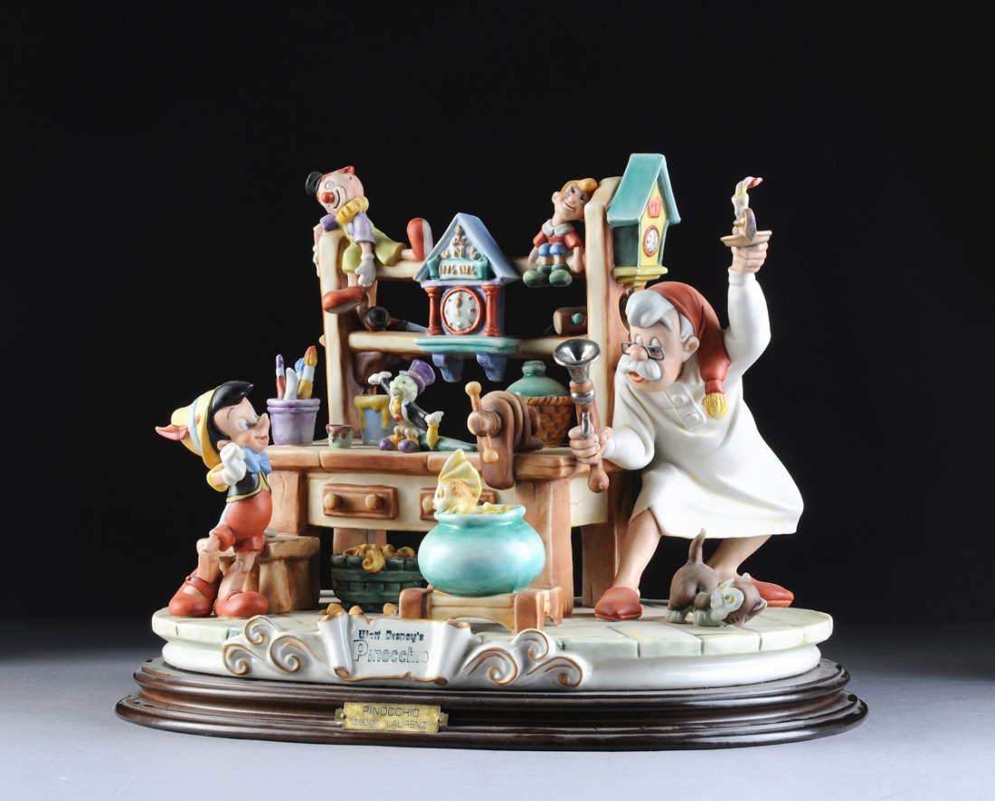 A CAPODIMONTE PORCELAIN SCULPTURE OF PINOCCHIO IN: A CAPODIMONTE PORCELAIN SCULPTURE OF PINOCCHIO IN GEPETTO'S WORK SHOP, FROM THE DISNEY LAURENZ CLASSIC COLLECTION. Jiminy Cricket, Cleo the goldfish, and Figaro the cat add their delightful presence t