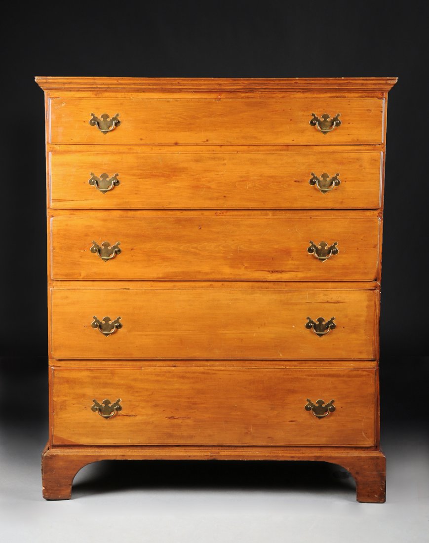 A CHIPPENDALE STYLE WALNUT TALL CHEST OF DRAWERS,: A CHIPPENDALE STYLE WALNUT TALL CHEST OF DRAWERS, AMERICAN, 18TH CENTURY, the rectangular top with molded cornice above five graduated drawers, raised on bracket feet. Height: 52 3/4" Width: 45" Depth