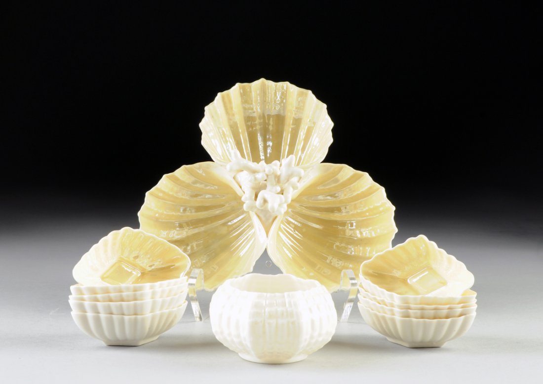 A COLLECTION OF BELLEEK EGG SHELL PORCELAIN TABLEWARES,: A COLLECTION OF BELLEEK EGG SHELL PORCELAIN TABLEWARES, IRELAND, SECOND AND THIRD PERIODS, CIRCA 1891-1946, comprised of ten open salts in scalloped diamond form, the cream porcelain with yellow lustr