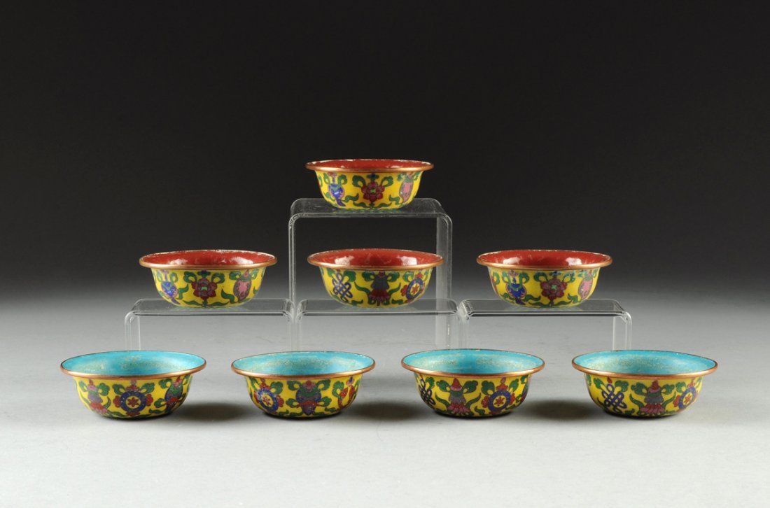 TWO SETS OF ANTIQUE CLOISONNÉ CHINESE YELLOW GROUND TEA: TWO SETS OF ANTIQUE CLOISONNÉ CHINESE YELLOW GROUND TEA CUPS, 19TH CENTURY, each of shallow bowl form with flaring rim and centering a colorfully enameled band of auspicious symbols above an undersid