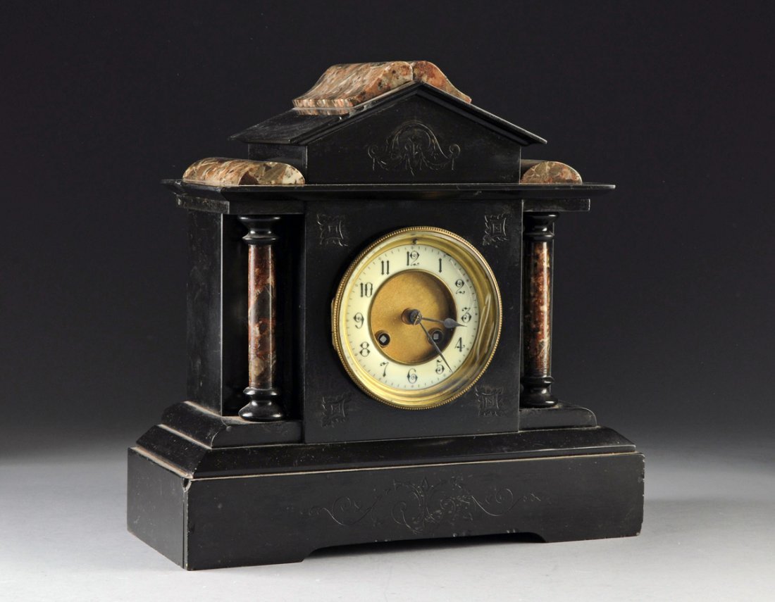 A FRENCH NEOCLASSICAL LACQUERED MARBLE AND SLATE MANTEL: A FRENCH NEOCLASSICAL LACQUERED MARBLE AND SLATE MANTEL CLOCK, 19TH/20TH CENTURY, having classical architectural elements featuring columns and raised on a plinth base, the enameled dial enclosed behi