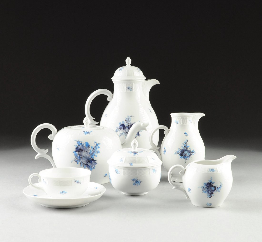 A NYMPHENBURG PORCELAIN COFFEE AND TEA SERVICE IN BLUE: A NYMPHENBURG PORCELAIN COFFEE AND TEA SERVICE IN BLUE FOR SEVEN, 20TH CENTURY, having hand painted blue floral sprays throughout, basket weave imprinted border accents, scrolling handles, with stampe