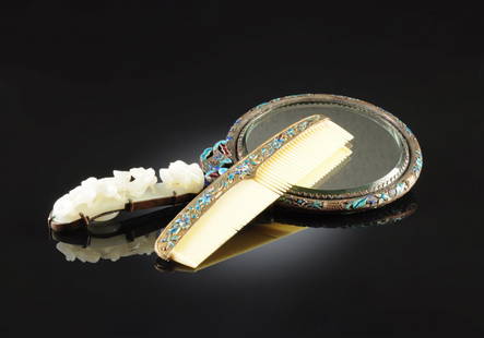 A VINTAGE CHINESE WHITE JADE MOUNTED POLYCHROME: A VINTAGE CHINESE WHITE JADE MOUNTED POLYCHROME ENAMELED HAND MIRROR AND COMB, LATE QING DYNASTY/EARLY REPUBLIC PERIOD, CIRCA 1900, the circular beveled mirror centered by a conforming silver metal fr