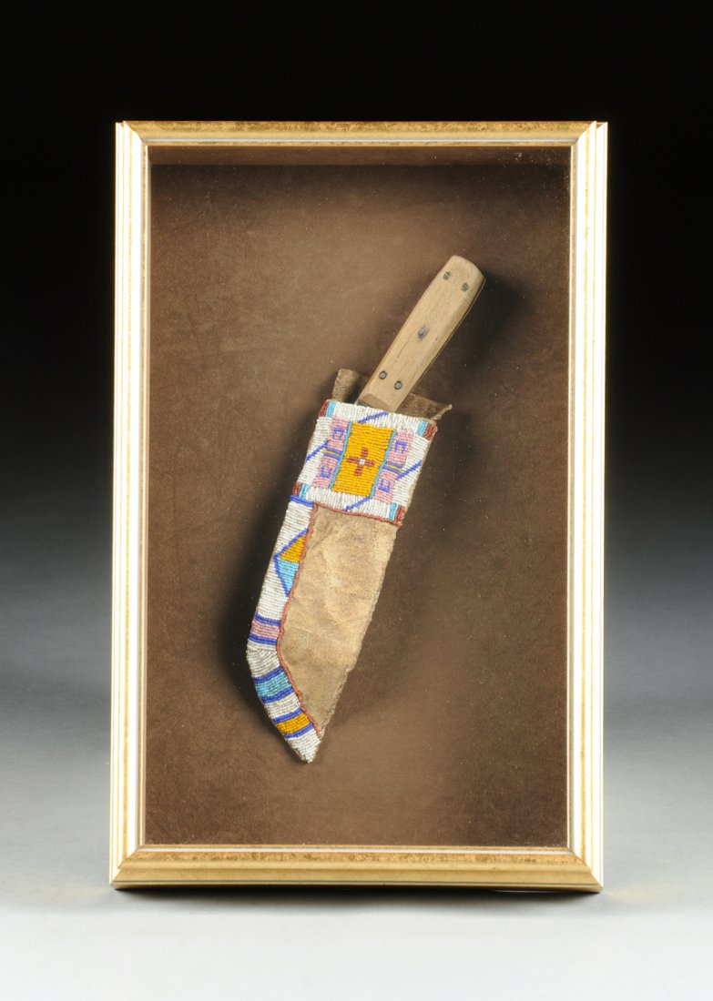 A CROW POLYCHROME BEADED HIDE KNIFE SHEATH WITH WOOD: A CROW POLYCHROME BEADED HIDE KNIFE SHEATH WITH WOOD HANDLED KNIFE, CIRCA 1890, the blade form sheath with a top panel centering colorful beading of traditional motifs continuing down a curved border,