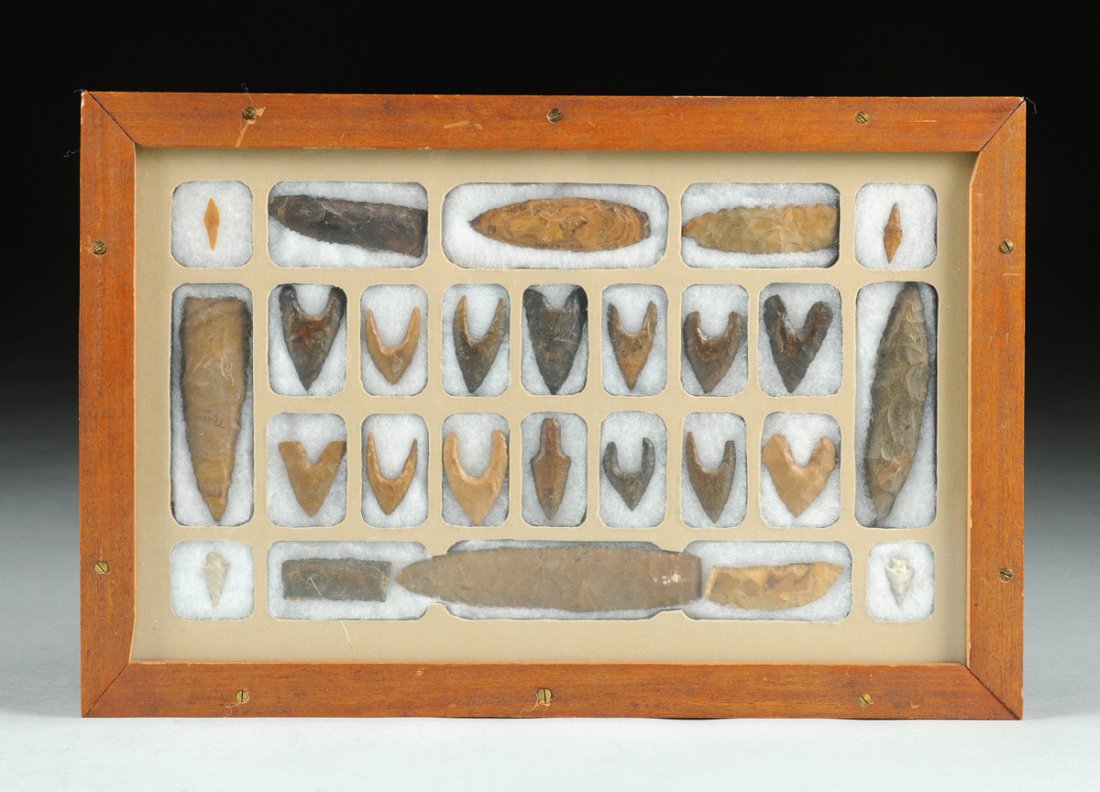 A TWENTY-SIX PIECE FRAMED NATIVE AMERICAN ARROW/SPEAR: A TWENTY-SIX PIECE FRAMED NATIVE AMERICAN ARROW/SPEAR HEAD COLLECTION, each of carved flint stone and a variety of forms, the smallest, length 1", the tallest 4 7/8".