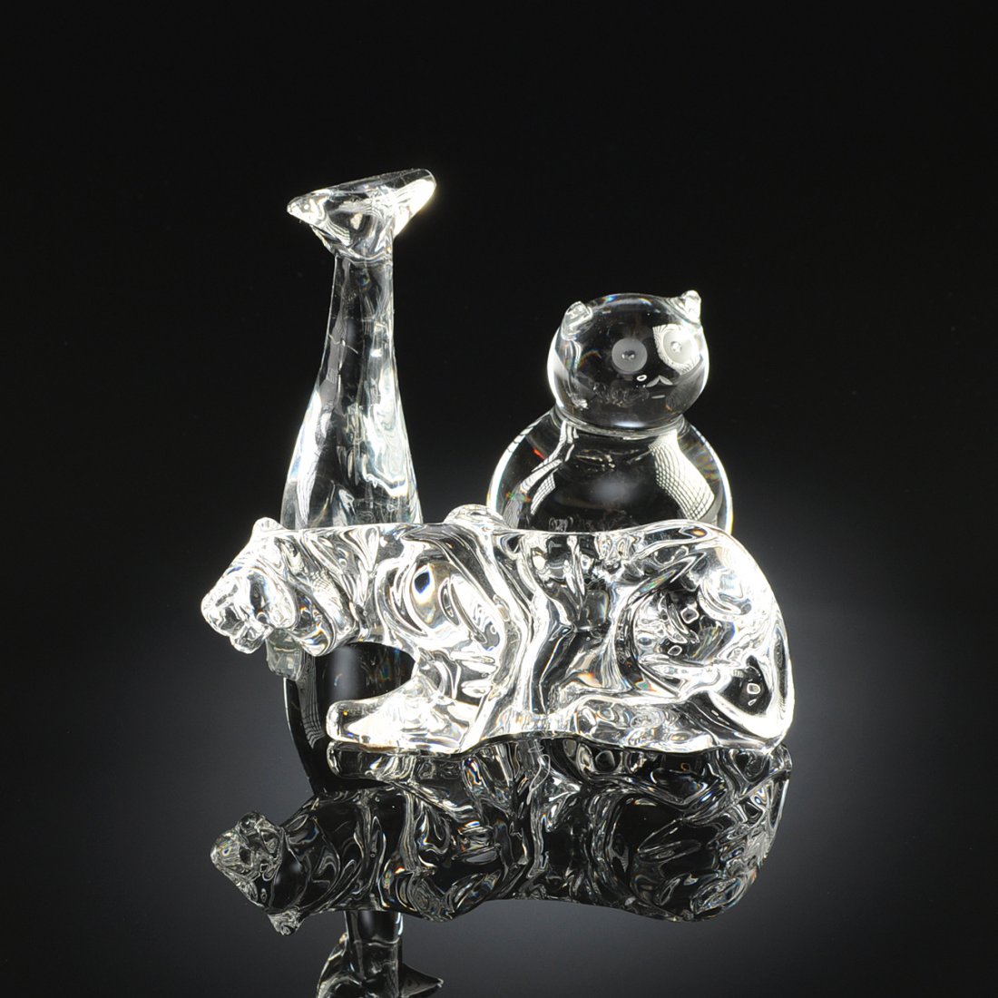 A GROUP OF THREE BACCARAT CRYSTAL FIGURES, FRANCE,: A GROUP OF THREE BACCARAT CRYSTAL FIGURES, FRANCE, MODERN, comprising a clear glass stylized figure of a sitting cat formed of two balls and etched eyes, height: 3 3/8"; a clear glass stylized elongat
