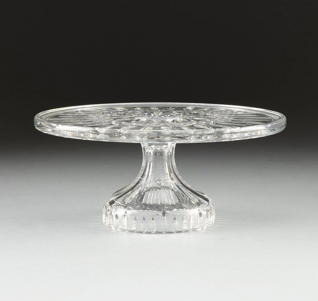 A WATERFORD CUT CRYSTAL ROUND CAKE STAND, IRELAND, LATE: A WATERFORD CUT CRYSTAL ROUND CAKE STAND, IRELAND, LATE 20TH CENTURY, the round cut glass cake stand in the Lismore pattern, introduced in 1957, raised on flaring stem, with acid etched mark Waterford