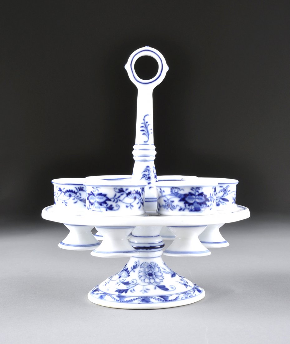 A SET OF SIX GERMAN PORCELAIN BLUE ONION PATTERN EGG: A SET OF SIX GERMAN PORCELAIN BLUE ONION PATTERN EGG CUPS AND STAND, BLUE CROSSED LINES AND "H", BY BROS. SCHOENAU, 1887-1900, of circular form with a shaped baluster stem partitioned by a conforming 
