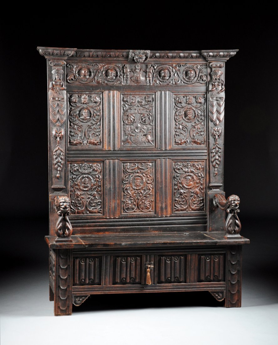 A RENAISSANCE STYLE CARVED OAK HALL SEAT, POSSIBLY: A RENAISSANCE STYLE CARVED OAK HALL SEAT, POSSIBLY ENGLISH, 19TH CENTURY AND OLDER, the foliate detailed rectangular cornice above a frieze of scrolling grotesques interspersed with portrait busts fla