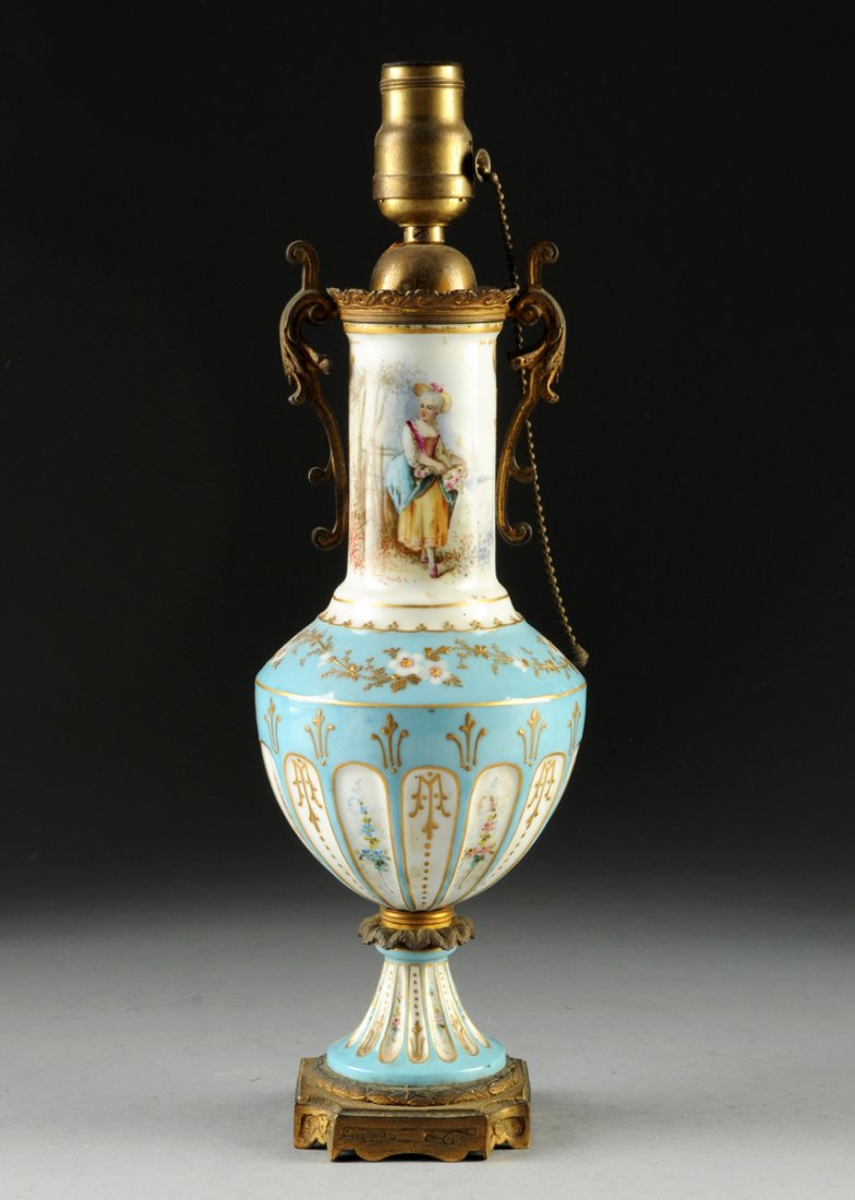 A SÈVRES STYLE GILT BRONZE BLEU CELESTE GROUND: A SÈVRES STYLE GILT BRONZE BLEU CELESTE GROUND PORCELAIN URN, the vasiform sides with raised parcel gilt alternating floral clusters above fluted panels of painted blossoming sprays, alternating rais