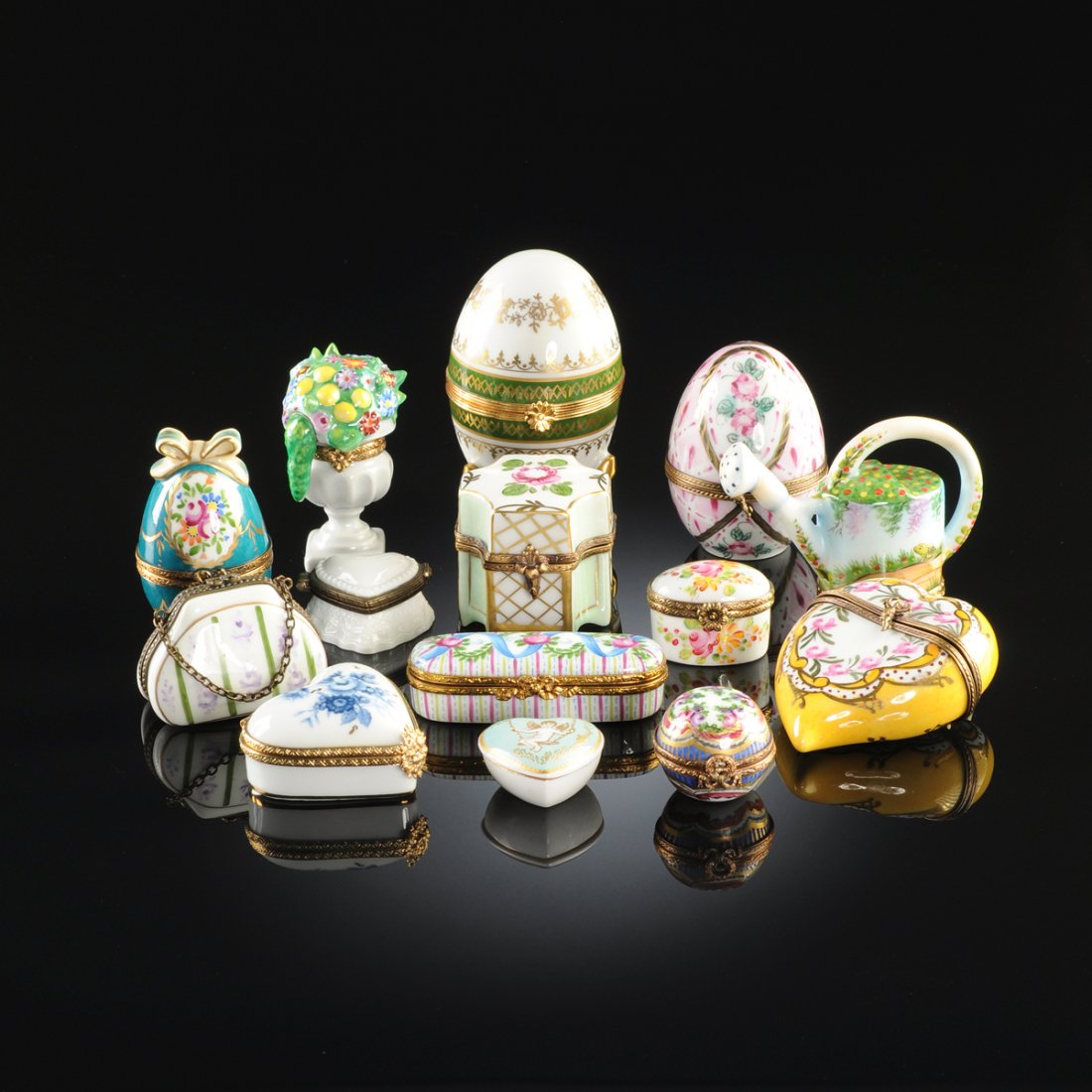 A GROUP OF FOURTEEN MINIATURE PORCELAIN AND ENAMEL: A GROUP OF FOURTEEN MINIATURE PORCELAIN AND ENAMEL FIGURAL BOXES, LATE 20TH CENTURY, comprising a Spode porcelain heart shaped box with transfer printed gilt figure of Cupid on celadon ground to lid; 
