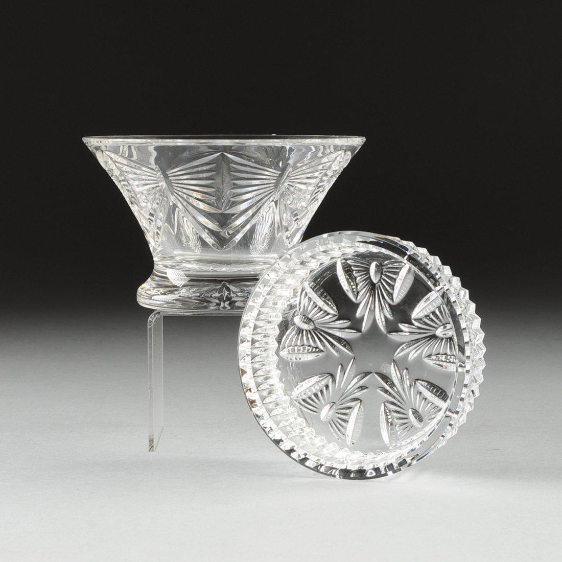 A GROUP OF TWO WATERFORD CUT CRYSTAL TABLE WARES,: A GROUP OF TWO WATERFORD CUT CRYSTAL TABLE WARES, IRELAND, LATE 20TH CENTURY, comprising a round bowl in the Best Wishes pattern, height: 3 3/4,diameter: 6 1/4"; and a wine bottle coaster in the Best