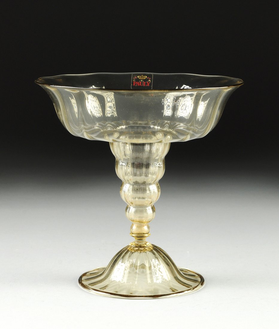 A MURANO TRANSPARENT GOLD COLORED COMPOTE BY THE PAULY: A MURANO TRANSPARENT GOLD COLORED COMPOTE BY THE PAULY & C. COMPAGNIA DI VENEZIA E MURANO, LATE 20TH CENTURY, the gentle twist lobed circular bowl on a tapering ribbed spheres modeled stem and domed b