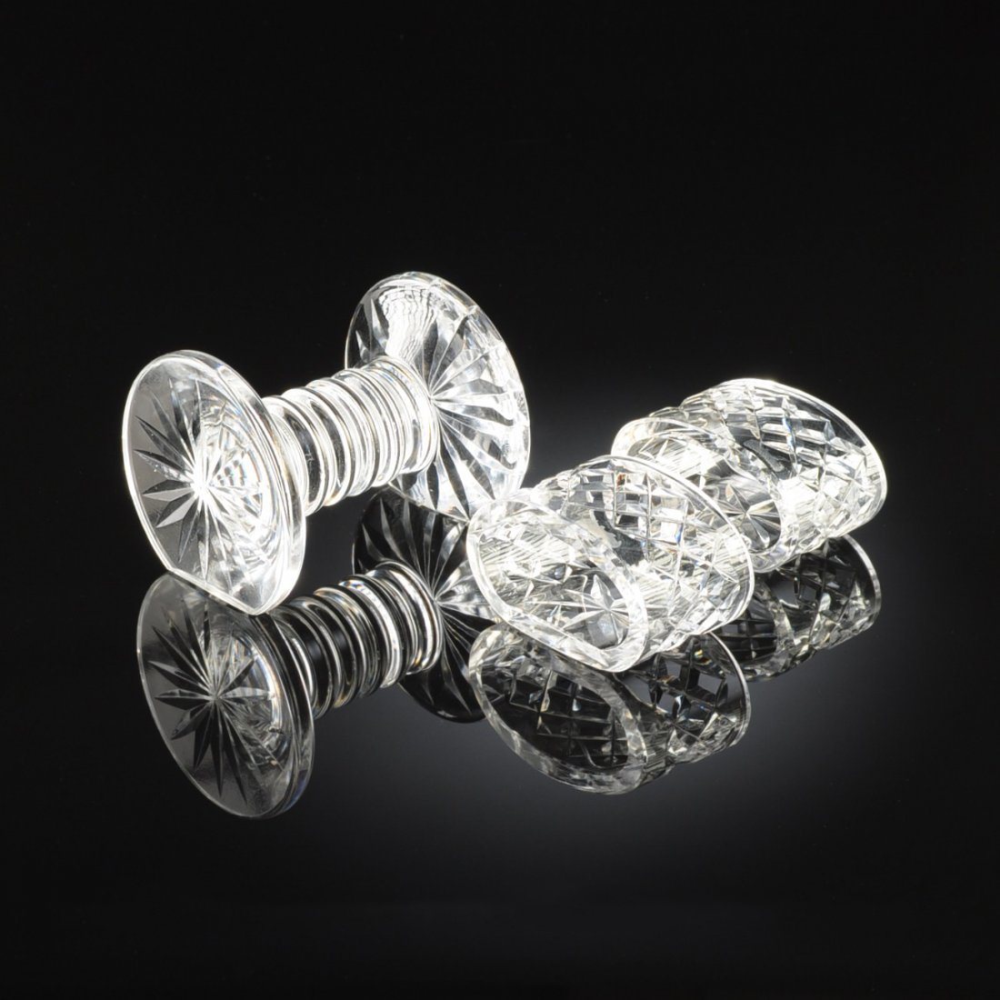 A GROUP OF THREE WATERFORD CUT CRYSTAL TABLE WARES,: A GROUP OF THREE WATERFORD CUT CRYSTAL TABLE WARES, IRELAND, LATE 20TH CENTURY, comprising a knife rest with a sixteen pointed cut star on each end, height: 2 5/8", width: 3 1/4", depth: 2 7/8"; and a