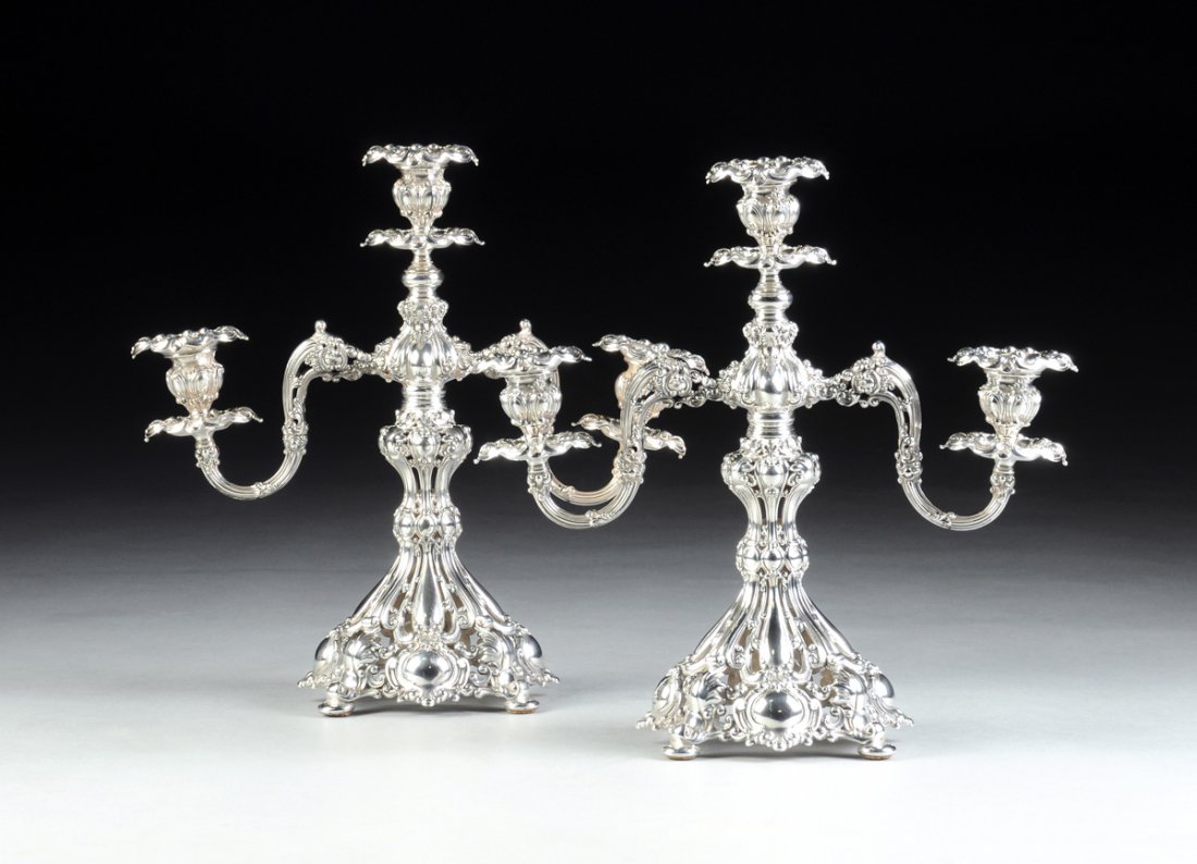 A PAIR OF REED & BARTON SILVER PLATED THREE-LIGHT: A PAIR OF REED & BARTON SILVER PLATED THREE-LIGHT CANDELABRAS, PATTERN 800, 20TH CENTURY, in a Renaissance Revival style with a reticulated knob stem issuing scrolling foliate detailed branches ending