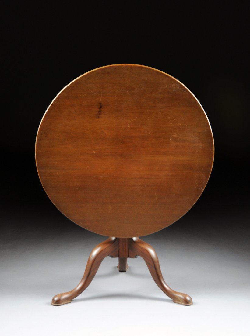 AN AMERICAN QUEEN ANNE CARVED MAHOGANY TILT-TOP TEA: AN AMERICAN QUEEN ANNE CARVED MAHOGANY TILT-TOP TEA TABLE, SECOND-HALF 18TH CENTURY, the circular peg hinged top on a baluster and ring turned stem, raised on a tripod base with cabriole splayed legs