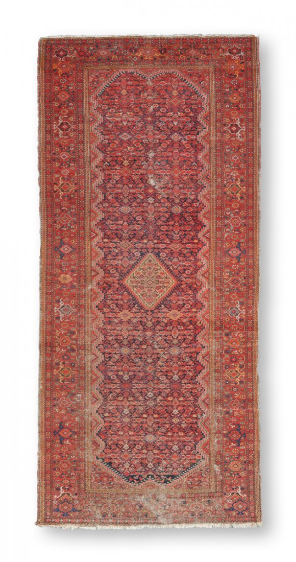 AN ANTIQUE PERSIAN MALAYER CARPET,: AN ANTIQUE PERSIAN MALAYER CARPET, the rust field centering a diamond lozenge within a surround of stylized flower heads and trailing vinery within a conforming border. 11' 5" x 5' 6"