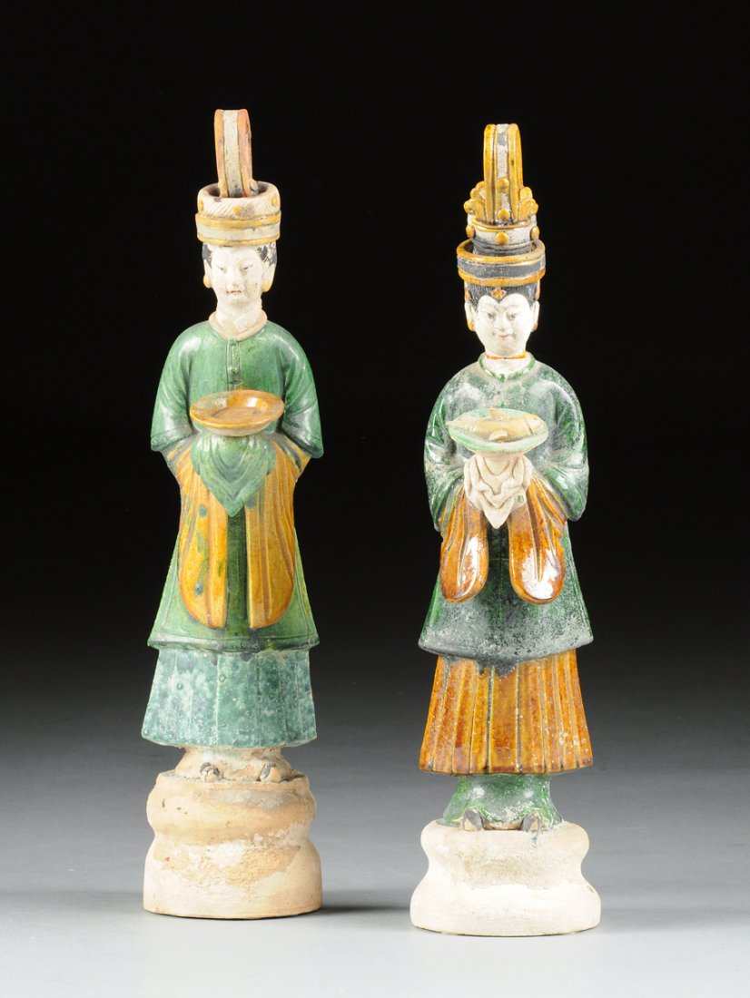 TWO CHINESE SANCAI GLAZED POTTERY FIGURES OF LADY COURT: TWO CHINESE SANCAI GLAZED POTTERY FIGURES OF LADY COURT ATTENDANTS, POSSIBLY MING DYNASTY (1368-1644), each modeled wearing an elaborate headdress above serene expressions and traditional long robes p
