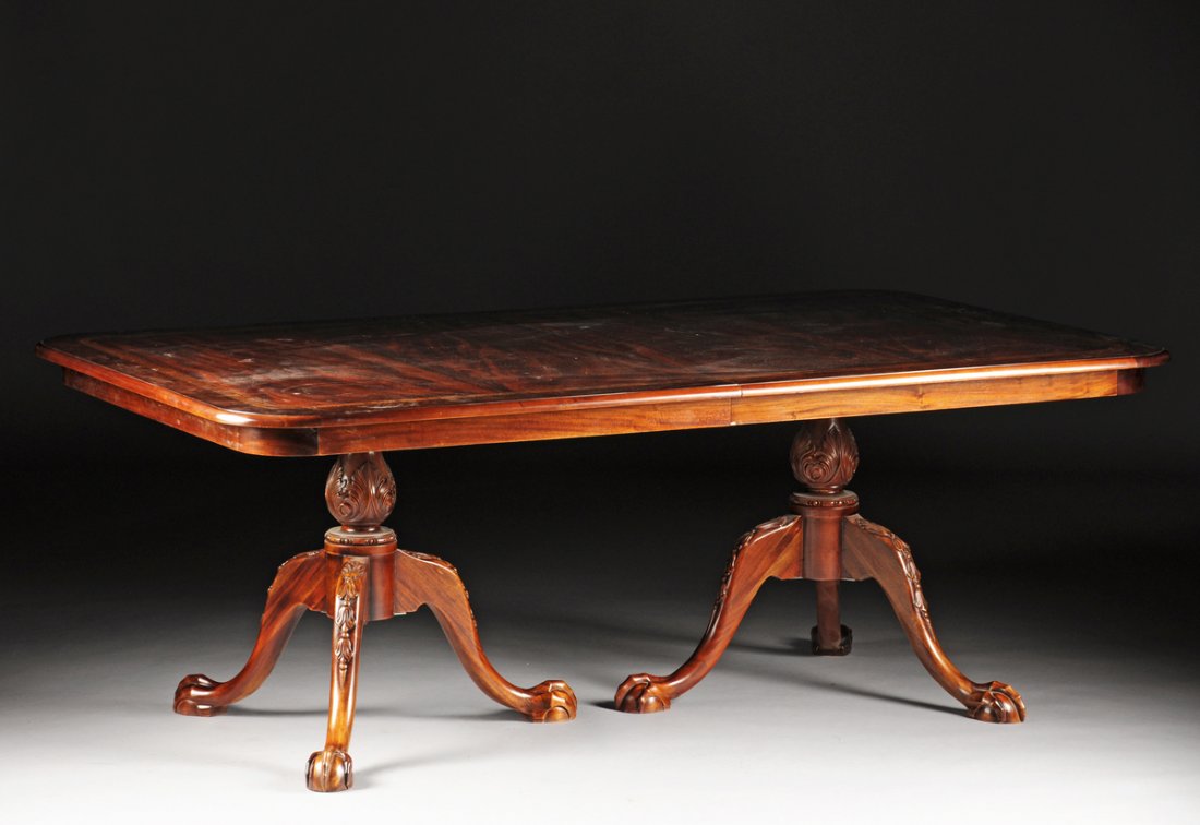 A CHIPPENDALE STYLE MAHOGANY DINING TABLE, 20TH: A CHIPPENDALE STYLE MAHOGANY DINING TABLE, 20TH CENTURY, with additional leaf, the table with rounded corners and half bullnose bevel with burled rim and fruitwood and ebony bands, the center of a dee