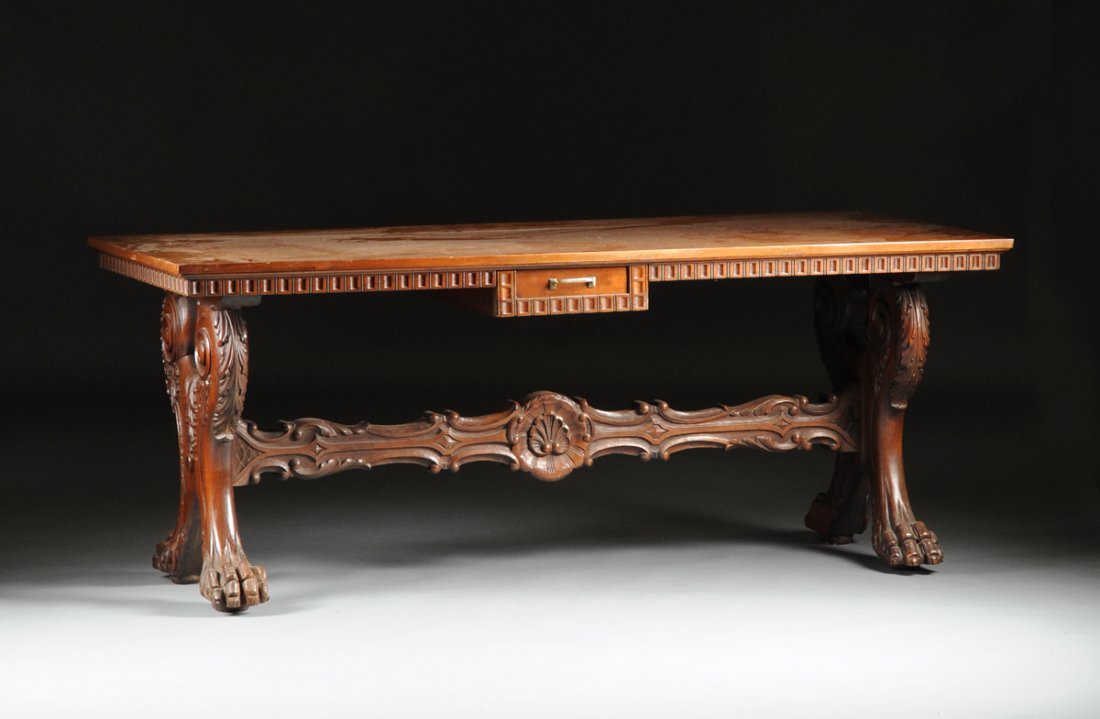 AN ITALIAN RENAISSANCE STYLE CARVED WALNUT REFECTORY: AN ITALIAN RENAISSANCE STYLE CARVED WALNUT REFECTORY TABLE, POSSIBLY TUSCAN OR FLORENTINE, LATE 19TH/EARLY 20TH CENTURY, the rectangular cross-banded top above a frieze of continuous scalloped square