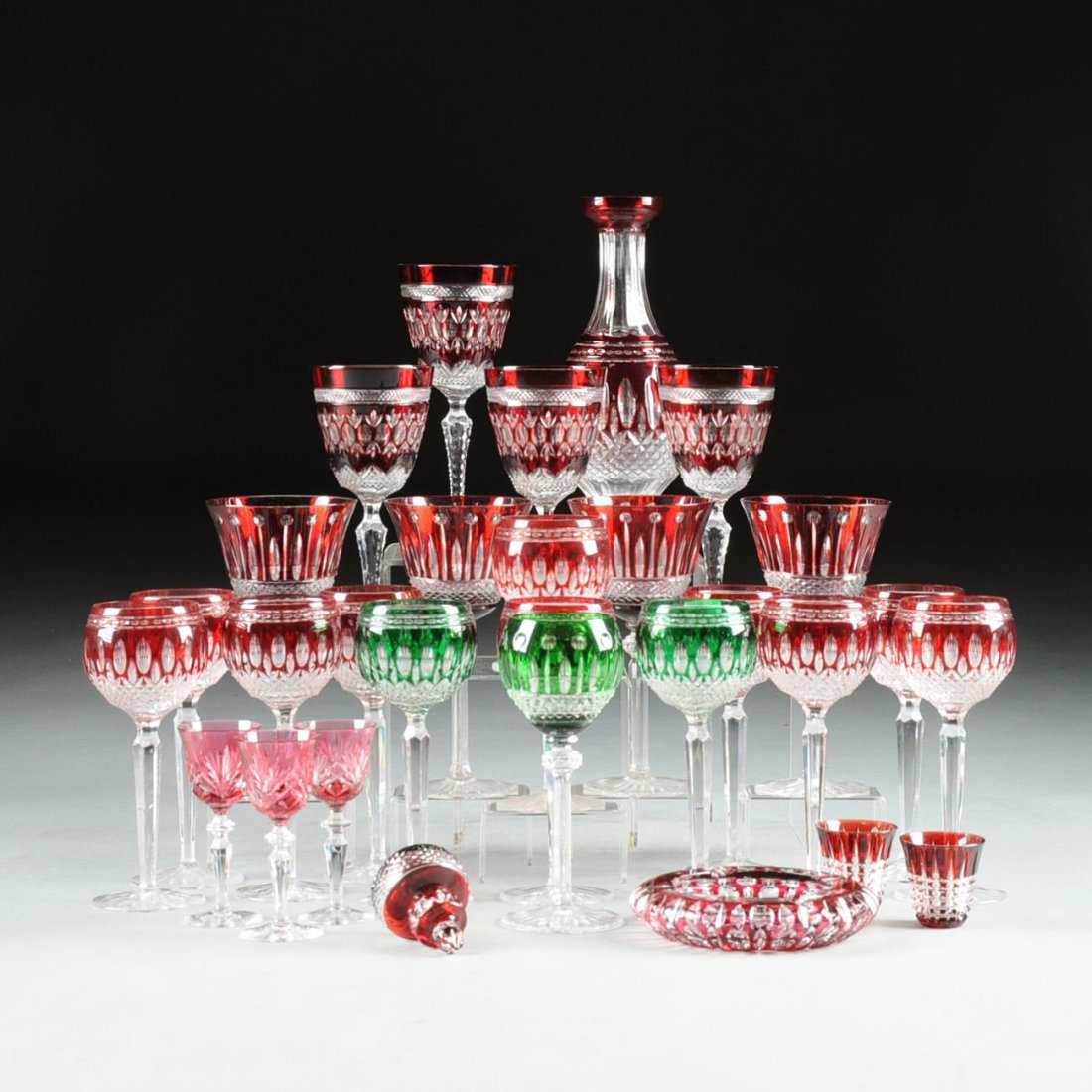 A GROUP OF TWENTY-NINE PIECES OF IRISH AND CONTINENTAL: A GROUP OF TWENTY-NINE PIECES OF IRISH AND CONTINENTAL CUT RUBY, EMERALD, AND GOLD RUBY CASED GLASS, MODERN, comprising ten Waterford crystal ruby cased wine hocks in the Clarendon pattern, produced 1