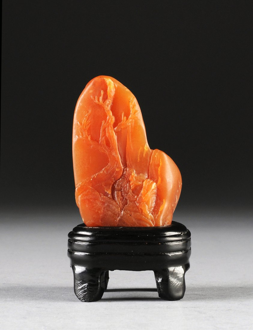 A CHINESE SHOUSHAN SOAPSTONE CARVING, POSSIBLY EARLY: A CHINESE SHOUSHAN SOAPSTONE CARVING, POSSIBLY EARLY 20TH CENTURY, of boulder form and caramel color with reddish brown inclusions enclosing a nicely detailed bearded sage wearing long robes beneath a
