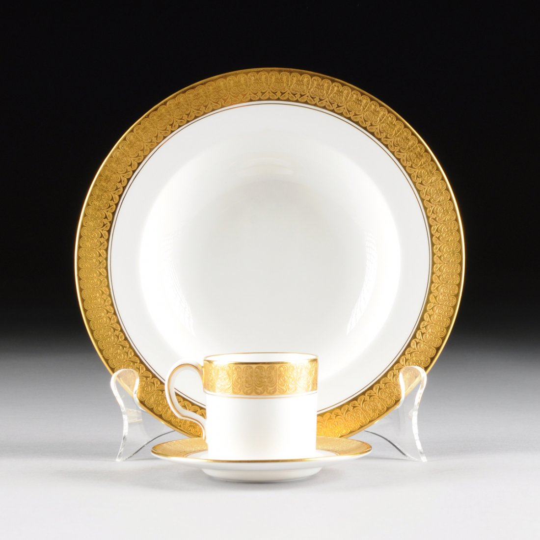A THIRTY SIX PIECE ROYAL CROWN DERBY PARCEL GILT WHITE : A THIRTY SIX PIECE ROYAL CROWN DERBY PARCEL GILT WHITE GROUND DEMITASSE AND SOUP BOWL SET, ST. GEORGE PATTERN, OVERGLAZE RED AND IMPRESSED MARKS, 1931, each with traditional heavily gilt banded rim, r