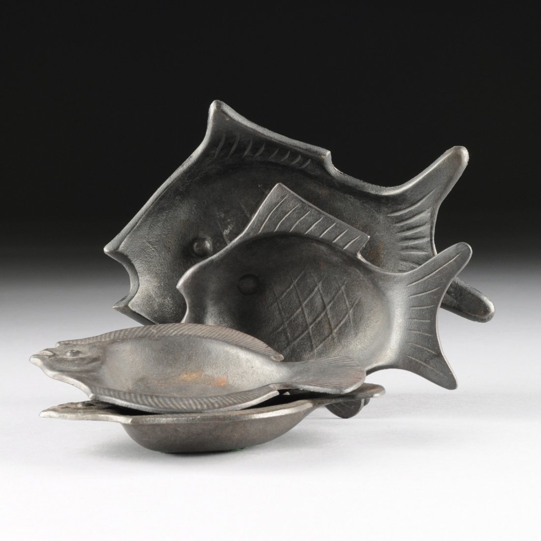 A GROUP OF FOUR JAPANESE CAST IRON FISH FORM ASHTRAYS,  (1 of 7)