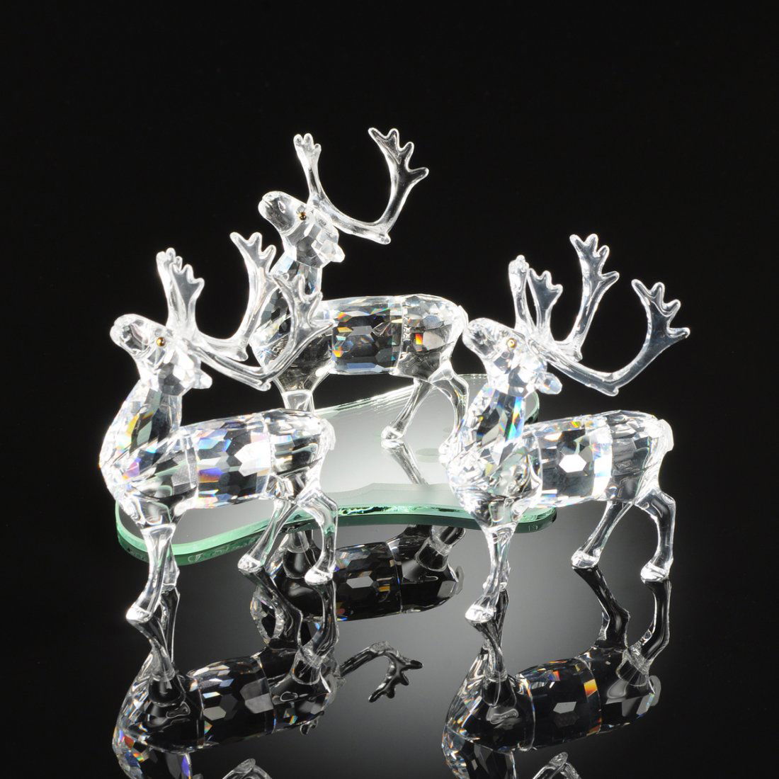 A GROUP OF THREE SWAROVSKI CRYSTAL MINIATURE REINDEERS, (1 of 6)
