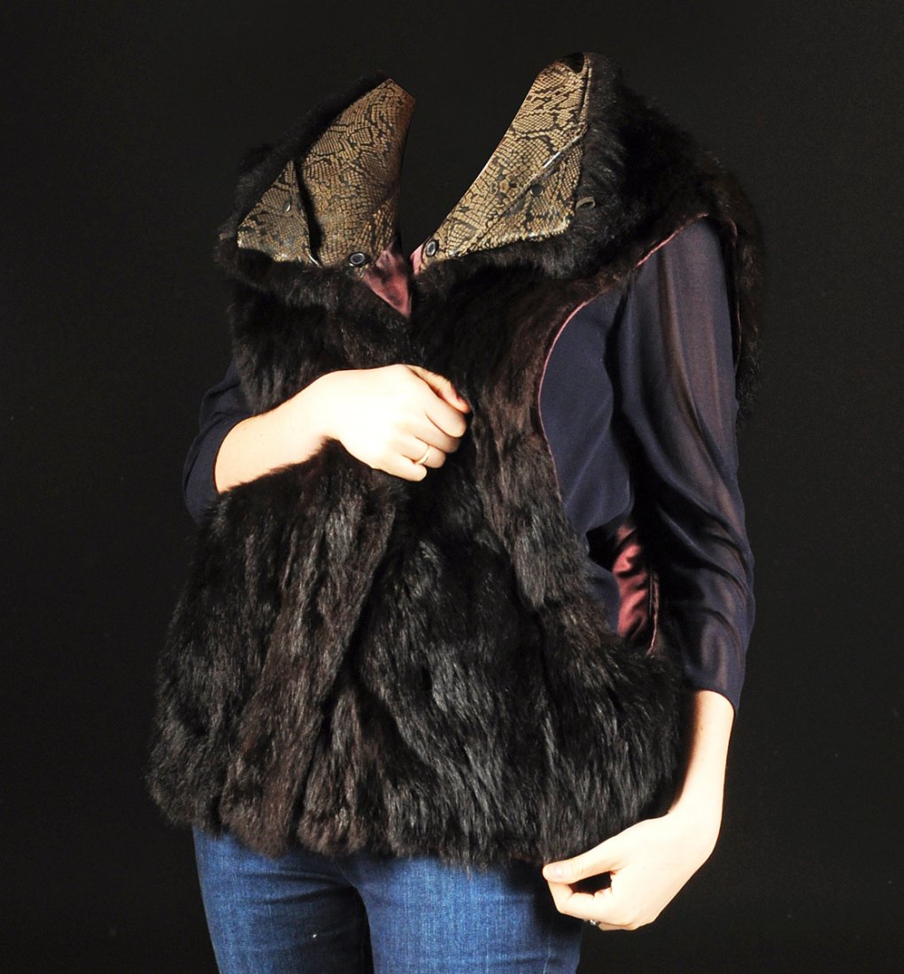 A NEW ZEALAND OPOSSUM WOMAN'S VEST, BY ANDREW MARC,: A NEW ZEALAND OPOSSUM WOMAN'S VEST, BY ANDREW MARC, SIZE MEDIUM, MODERN, vertical deep brownish black pelts with aubergine color acetate lined interior, as well as brown faux reptile stamped leather l