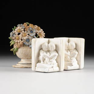 A PAIR OF WHITE PLASTER FIGURAL BOOK ENDS AND ONE: A PAIR OF WHITE PLASTER FIGURAL BOOK ENDS AND ONE POLYCHROME PAINTED CAST IRON BOOK END, 20TH CENTURY, each of the pair of white plaster book ends are modeled as a boy and girl child seated together