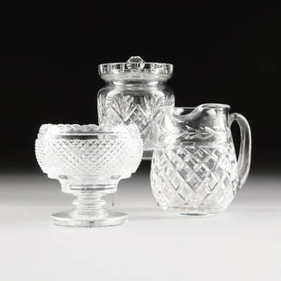 A COLLECTION OF THREE WATERFORD CUT GLASS VESSELS,: A COLLECTION OF THREE WATERFORD CUT GLASS VESSELS, SIGNED, 20TH CENTURY, comprising a large footed bon bon dish, with a scalloped fan cut rim over the rounded diamond-cut bowl and stepped stem over a