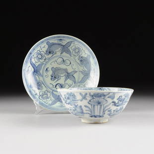 TWO VIETNAMESE/ANNAMESE BLUE AND WHITE GLAZED STONEWARE: TWO VIETNAMESE/ANNAMESE BLUE AND WHITE GLAZED STONEWARE DISHES, each decorated with underglaze cobalt blue and comprising a shallow charger centering a stylized goldfish within double banded border
