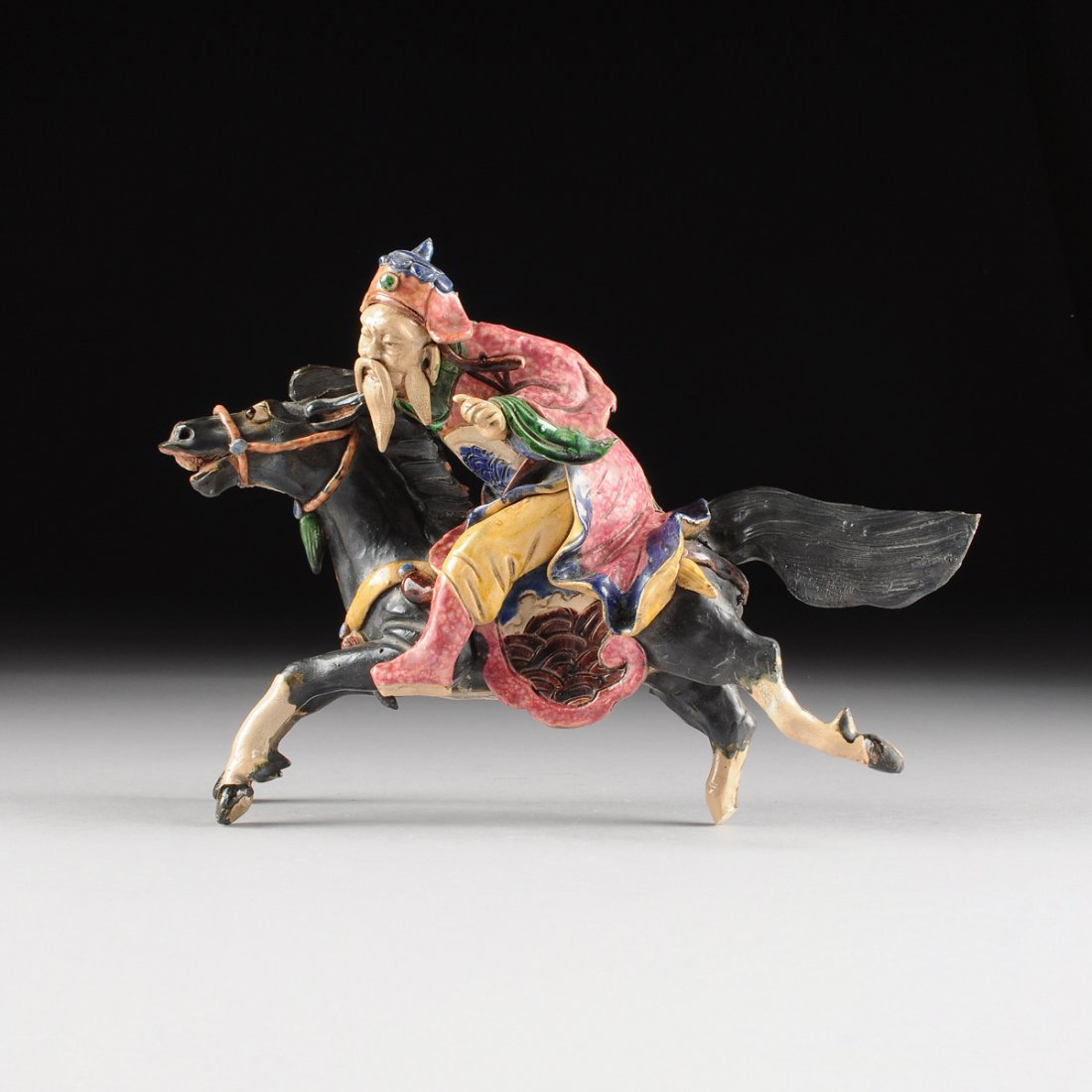 A CHINESE POLYCHROME PAINTED CERAMIC EQUESTRIAN (1 of 10)