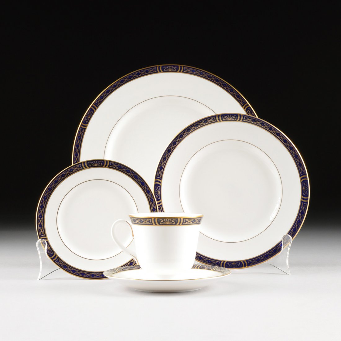 A FIFTY-EIGHT PIECE ROYAL WORCESTER PARCEL GILT AND: A FIFTY-EIGHT PIECE ROYAL WORCESTER PARCEL GILT AND COBALT BLUE ENAMELED PORCELAIN PARTIAL DINNER SERVICE, "MOUNTBATTEN COBALT BLUE" PATTERN, MAKER'S MARK, CIRCA 1979, each with a cobalt blue enameled