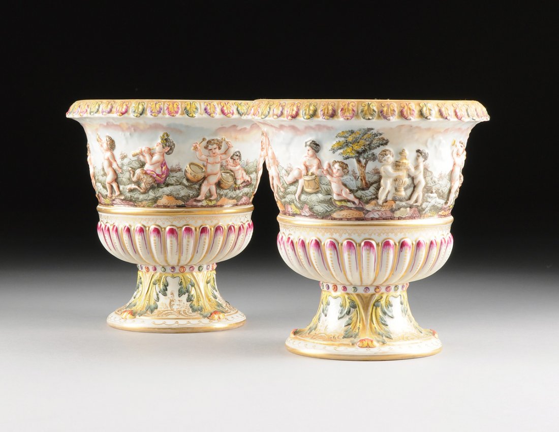 A PAIR OF CAPODIMONTE STYLE POLYCHROME PAINTED AND: A PAIR OF CAPODIMONTE STYLE POLYCHROME PAINTED AND MOLDED PORCELAIN VASES, PROBABLY DRESDEN, UNDERGLAZE BLUE CROWNED "N" MARK, LATE 19TH/EARLY 20TH CENTURY, each with a stylized leaf tip and dart deco
