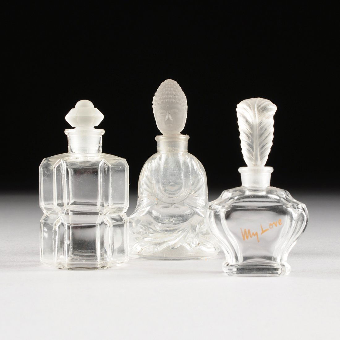 A GROUP OF THREE FROSTED AND CLEAR MOLDED GLASS PERFUME (1 of 10)