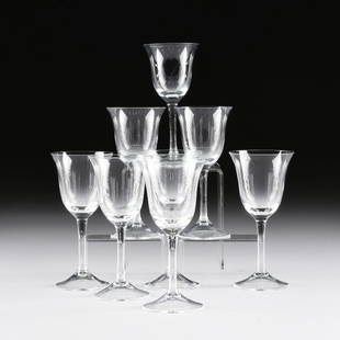 A SET OF EIGHT CRYSTAL DESSERT WINE STEMWARE,: A SET OF EIGHT CRYSTAL DESSERT WINE STEMWARE, each with flared rim cut detailed bowl on a tapering circular stem ending on a conforming base. Modern. Height: 6 1/4"