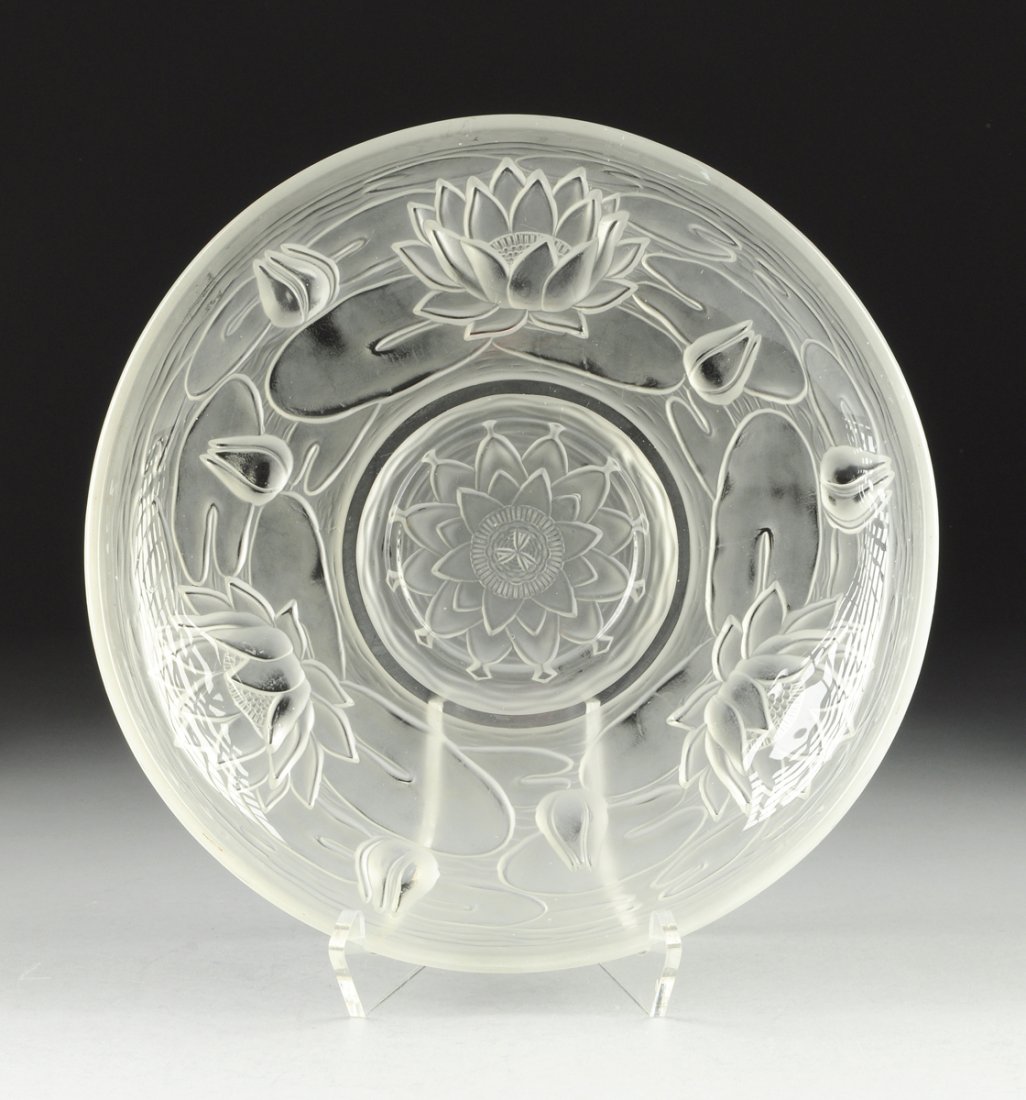 AN ART DECO STYLE SATIN TO CLEAR GLASS CENTER BOWL, BY: AN ART DECO STYLE SATIN TO CLEAR GLASS CENTER BOWL, BY AUGUSTE WALTHER AND SOHNE, GERMANY, EARLY 20TH CENTURY, in Waterlily pattern. The exterior molded in relief with floating lotus blossoms and lily