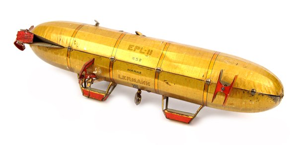 A Lehmann tinplate clockwork airship toy 652. 25cm. In: A Lehmann tinplate clockwork airship toy 652. 25cm. In anodised gold finish with red and black lithographed detailing, named ‘EPL.11’ with U.S. star markings. Also marked ‘652 Marke Lehmann’ a