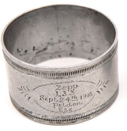 Destruction of L33 – Souvenir Napkin Ring. Aluminium: Destruction of L33 – Souvenir Napkin Ring. Aluminium alloy Napkin Ring (5cm diameter, 3cm high). Milled pattern around top and bottom of the ring, and in an oval frame to the front is engraved “Ze