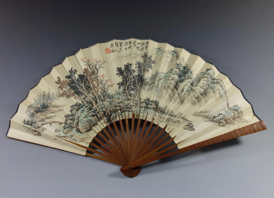 CHINESE PAINTED FAN BY WU WEI: Chinese ink and color painting fan, signed Wu Wei; depicting a landscape with mountainside and trees; inscription and seal mark. Dimension: 21" x 11.75"