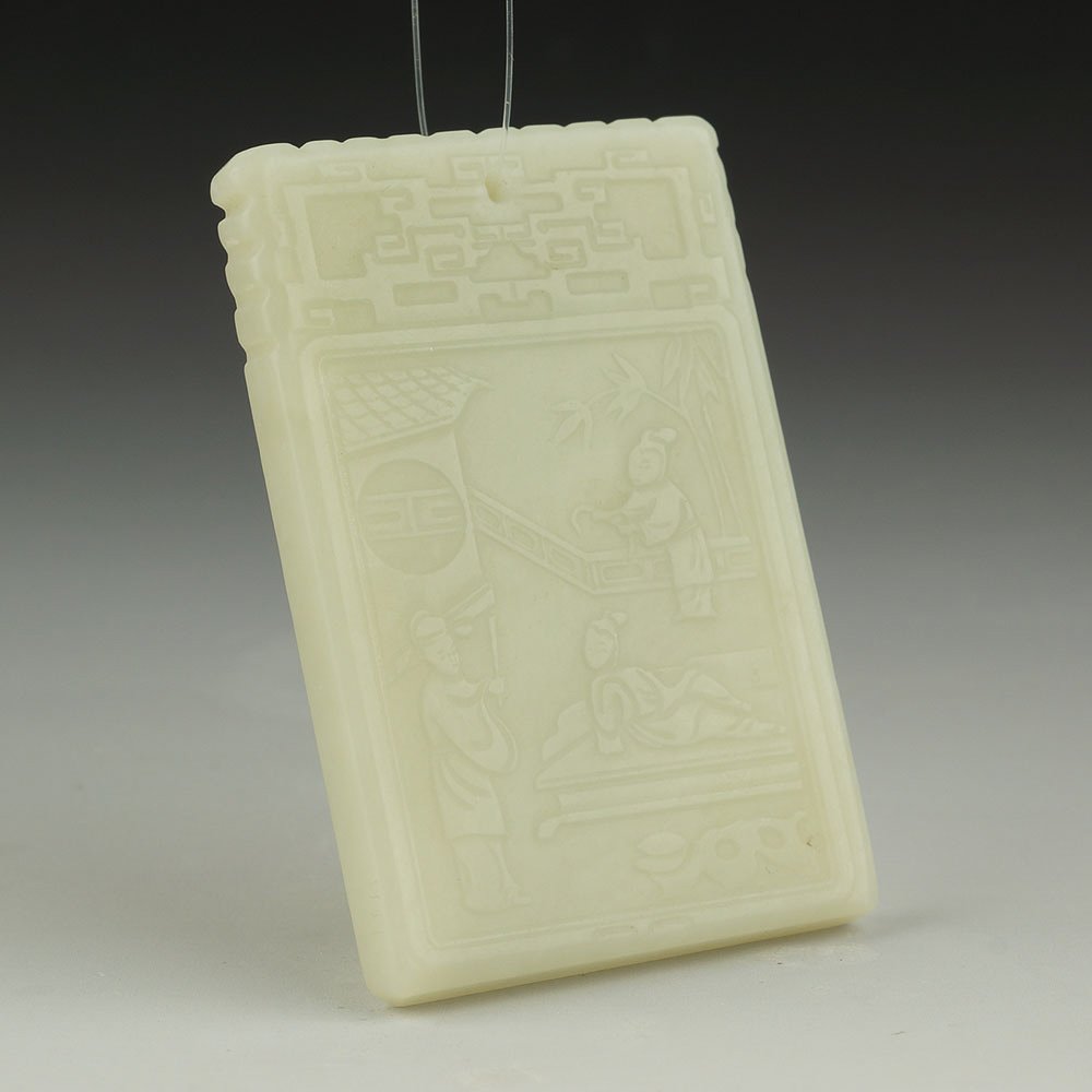 CHINESE XINJIANG CARVED NEPHRITE JADE PENDANT: Large Chinese Xinjiang rectangular nephrite jade pendant plaque; with low relief design of figures in a landscape to the front and calligraphy to the reverse; archaistic motif at the top. Size: 67 x 4
