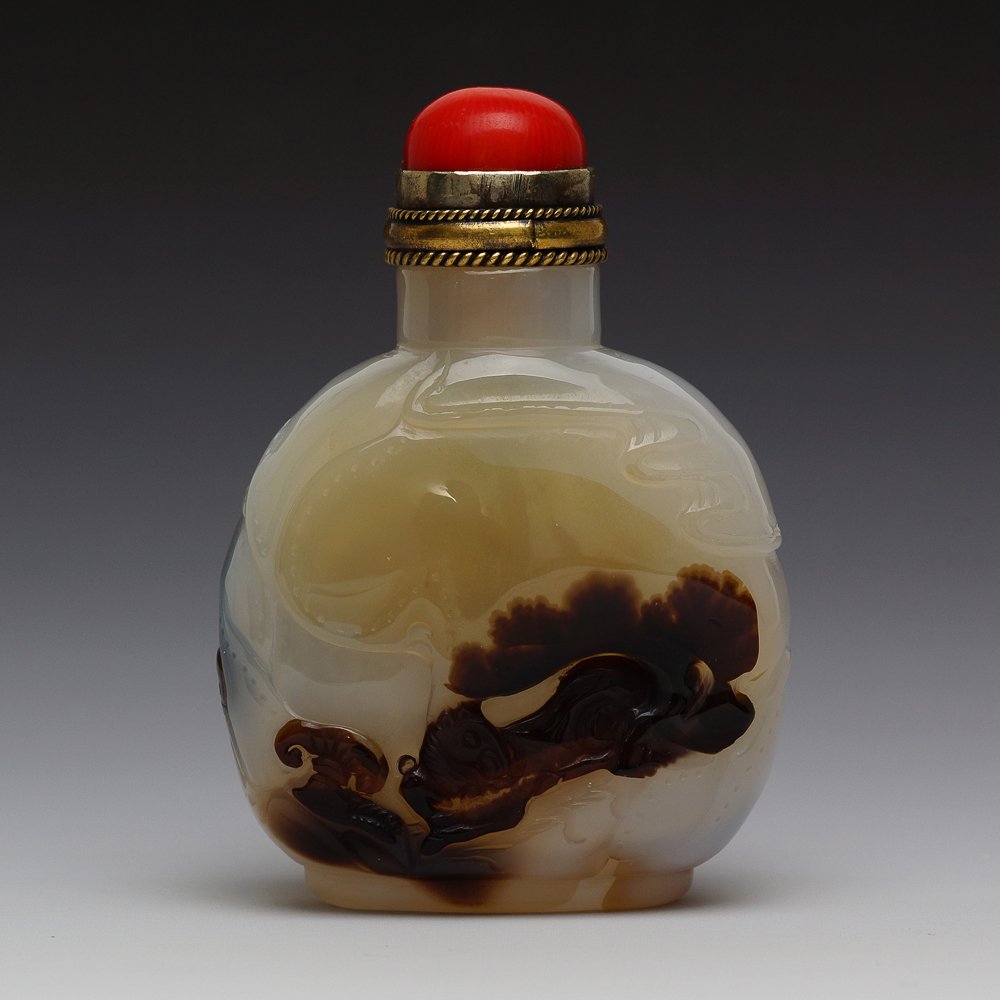 DOUBLE SIDED CARVED CHINESE AGATE SNUFF BOTTLE: Chinese finely hollowed, cameo carved agate snuff bottle; of flattened circular form with carved designs to both sides: beard scholar sitting in his courtyard with bridge and pavilion, and a horse lyi