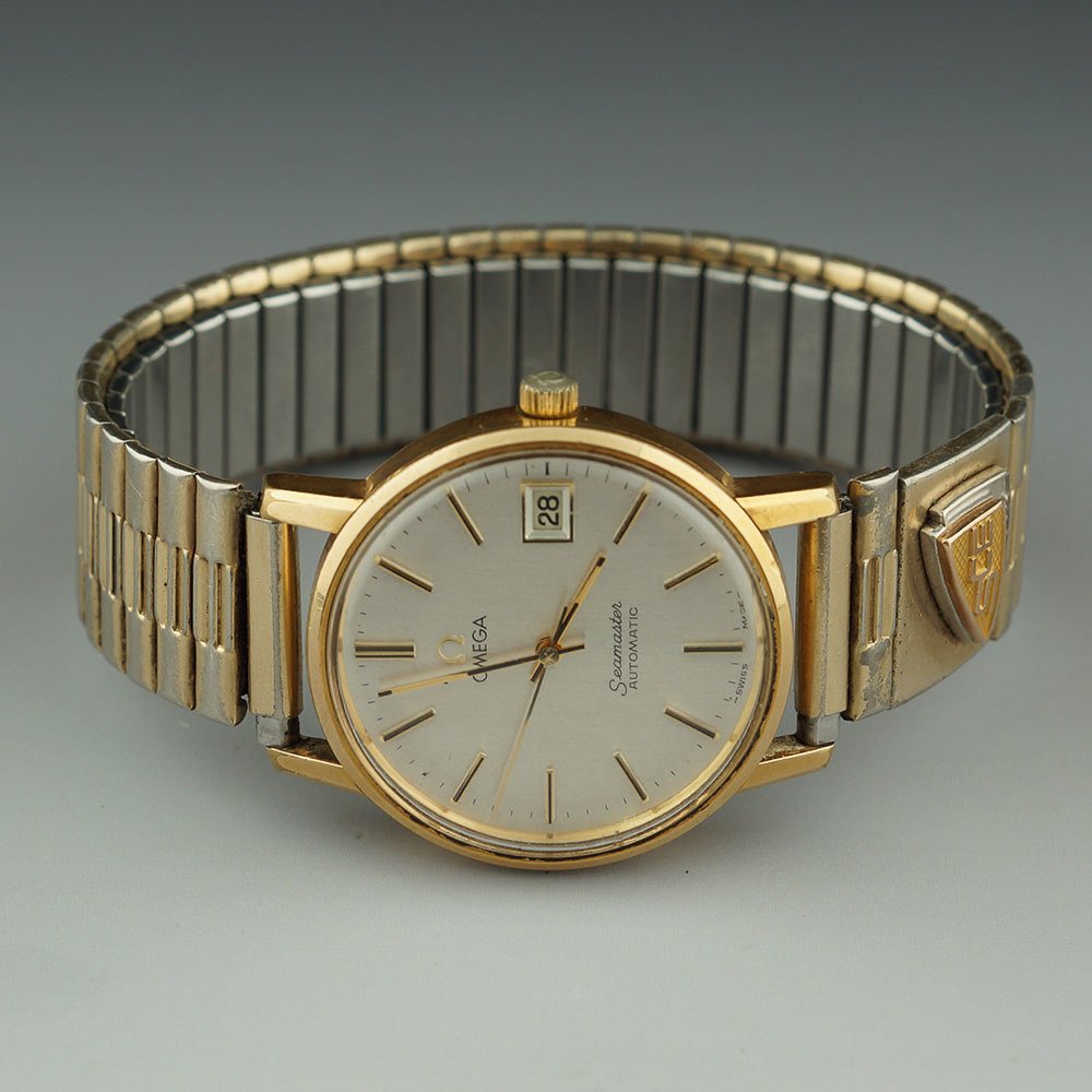 OMEGA SEAMASTER AUTOMATIC W/ SCE 14K GOLD SERVICE AWARD: Nice gold filled Omega Seamaster Automatic with 166.0202 movement. On the Speidel band is attached a 14k gold (tested) Southern California Edison Service Award Pin with 2 diamonds and one ruby. The ru