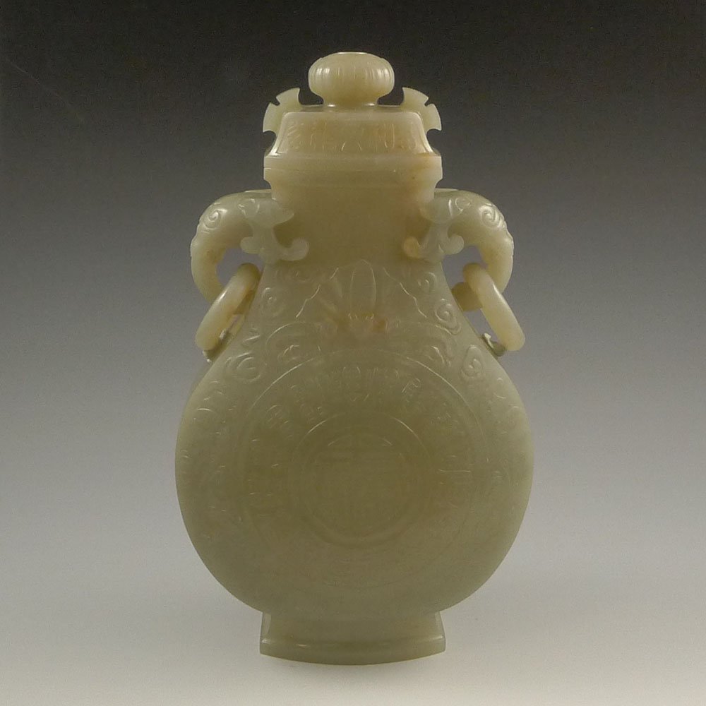 LARGE CHINESE CARVED JADE URN: Large and well carved, Chinese jade urn and cover; of somewhat archaistic bronze form, with elephant-headed handles pending loose rings. Size: 9.5 x 6 x 3.25 "